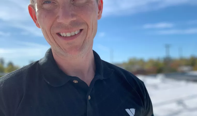 Man outdoors with Y staff shirt