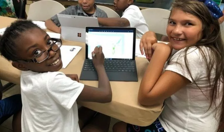 Girls at school with computer