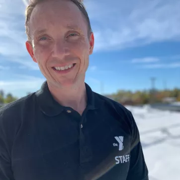 Man outdoors with Y staff shirt