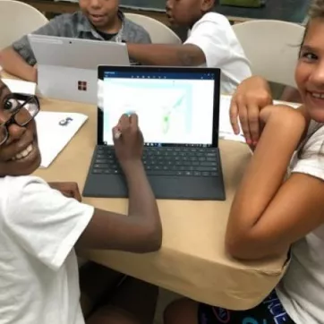 Girls at school with computer