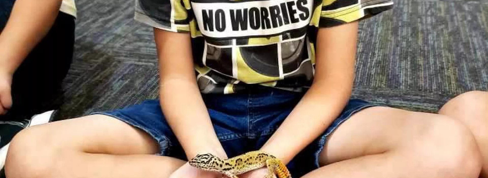 reptile boy holding lizard